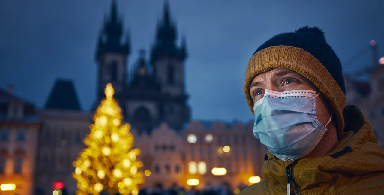 Man wearing face mask at Prague's Old Town Square via iStock / Chalabala
