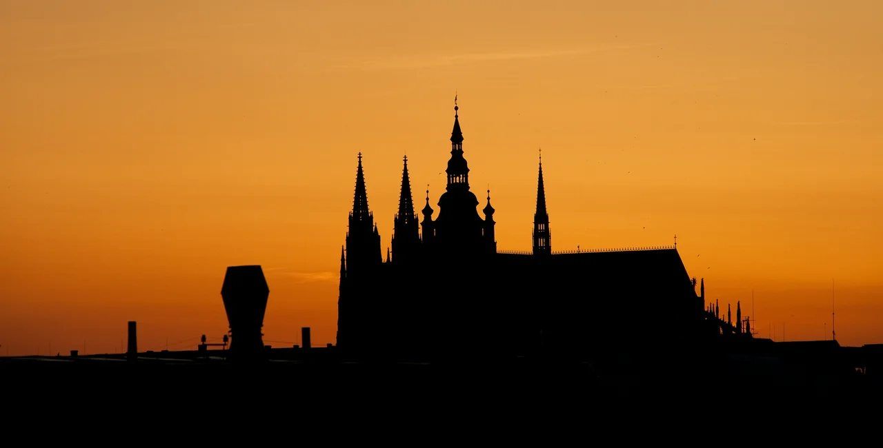 Prague Castle, silhouetted by the setting sun. (photo: James Fassinger - Expats.cz)