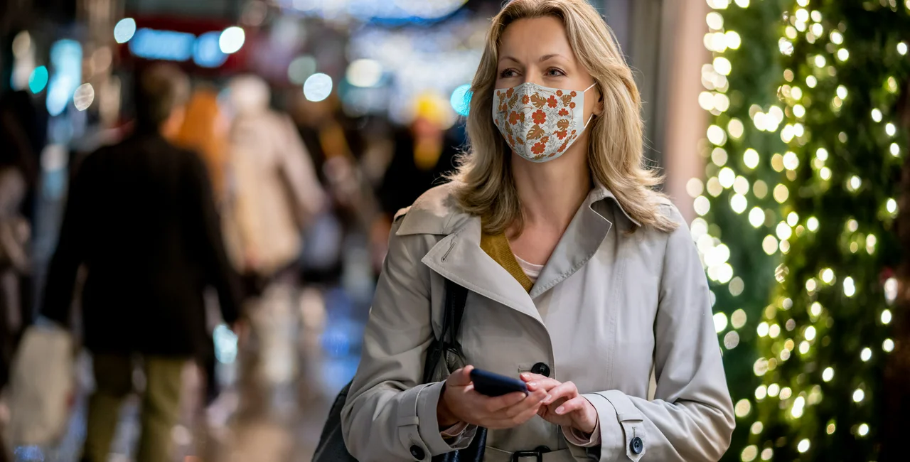 Woman wearing a face mask during the Christmas season via iStock / 
