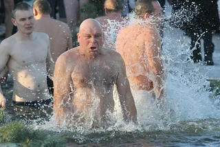 A man swims in cold water during the celebration of the Christian holiday of Baptism of Jesus in the village Kovalivka, Ukraine