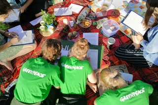 Greenpeace volunterrs write letters.