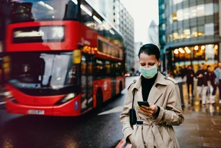 Woman in London wearing face mask via iStock / Drazen_