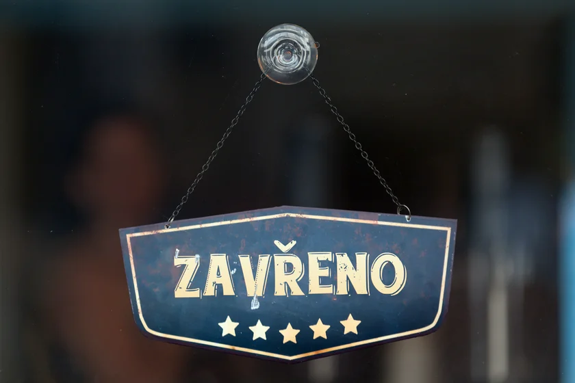 Old fashioned sign in the window of a shop saying in Czech 