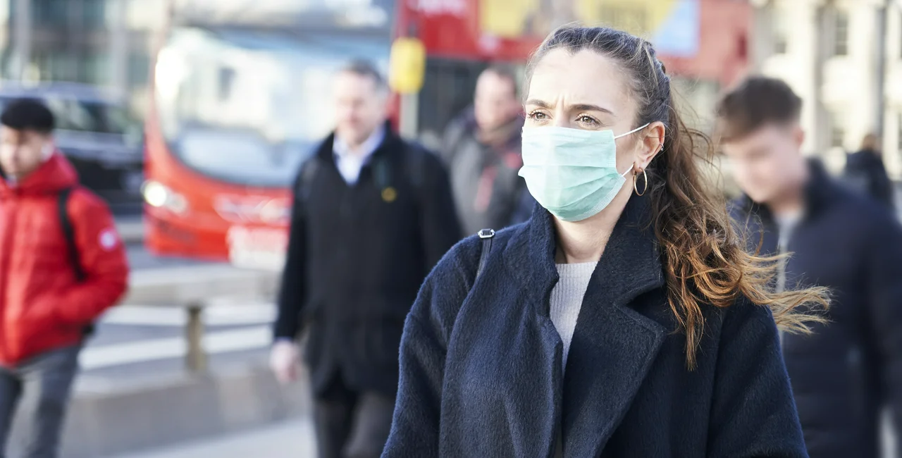 Woman with a face mask in London via iStock / gemphotography