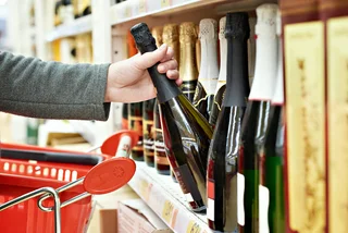 Bottles of champagne in a supermarket via iStock / sergeyryzhov