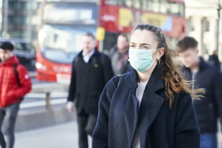 Woman with a face mask in London via iStock / gemphotography