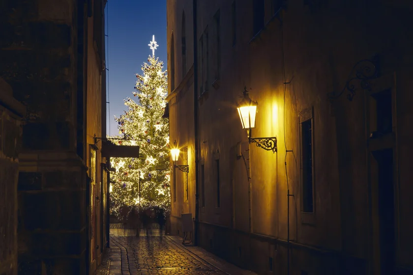 hristmas holiday in city. Narrow street Old Town against illuminated Christmas tree. Prague, Czech Republic (iStock photo /