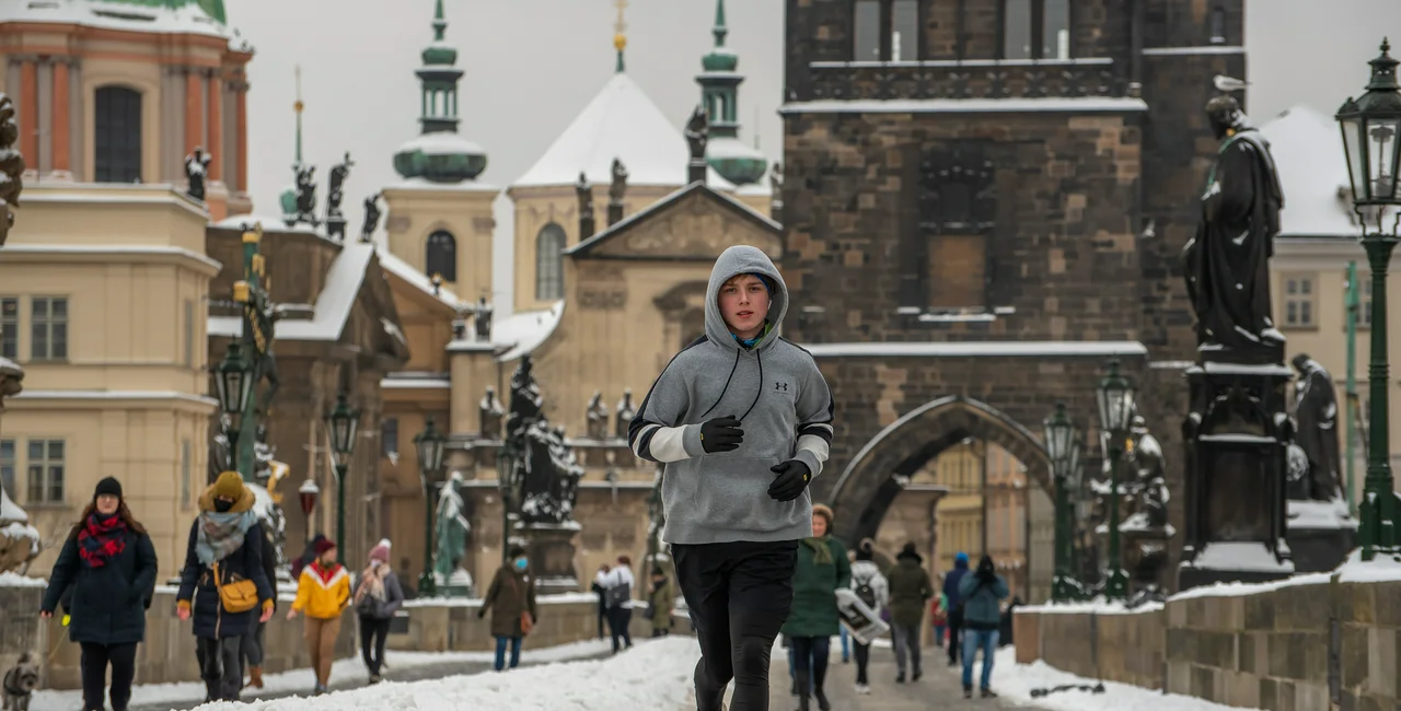 Man running on Prague's Charles Bridge via iStock / Humanitarian photographer working for UN Agencies