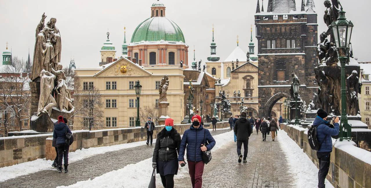 People walk on a snow-covered Charles Bridge in Prague, via iStock / Humanitarian photographer working for UN Agencies