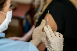 Vaccine being administered via iStock / Sneksy