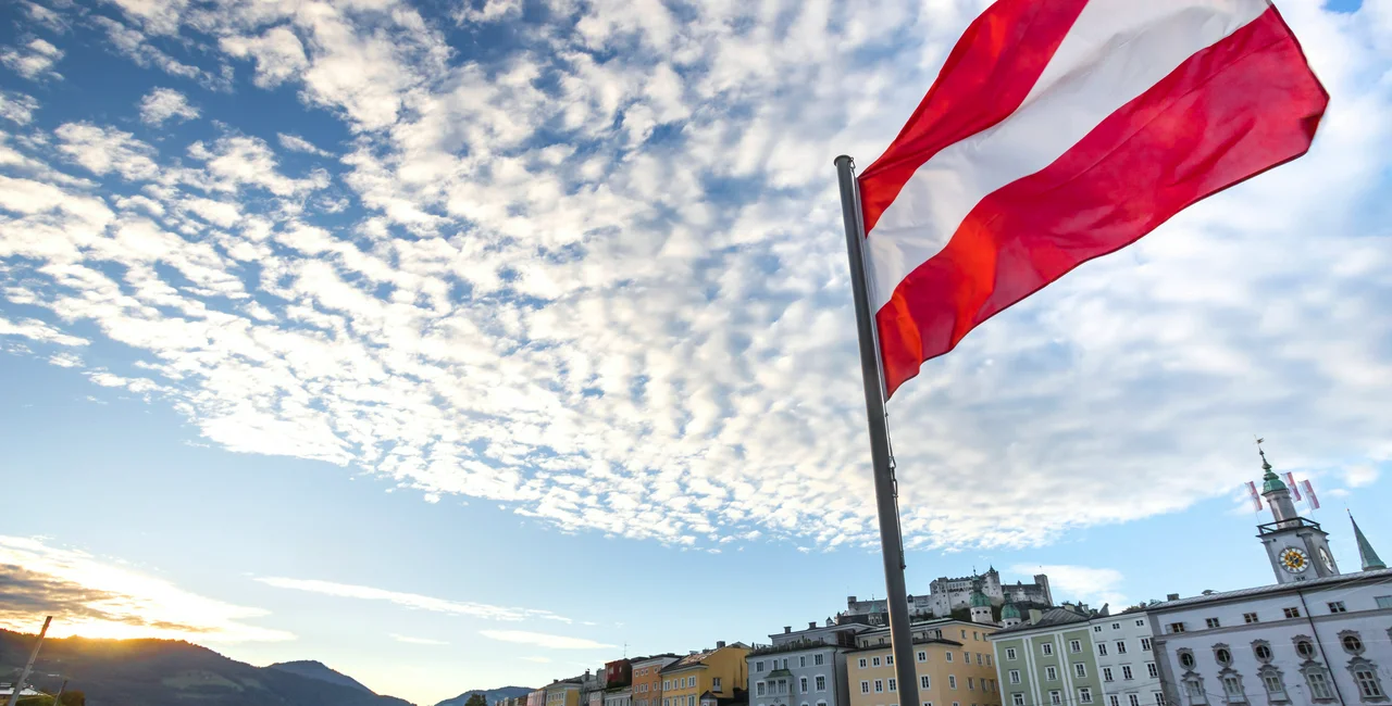 Austrian flag over Salzburg via iStock / Teka77