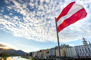 Austrian flag over Salzburg via iStock / Teka77