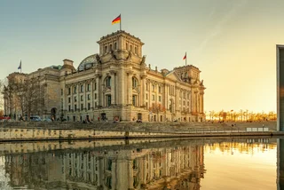 German flag atop Reichstag Building in Berlin via iStock / frankpeters