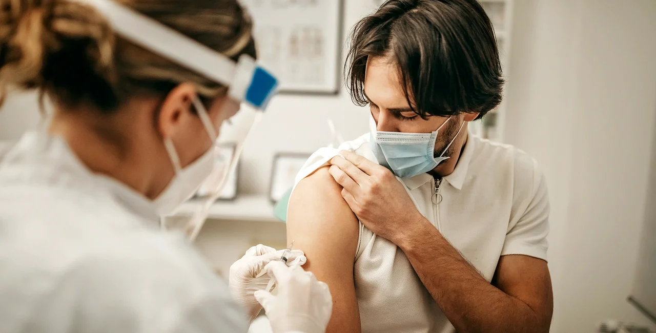 Doctor administering a Covid-19 vaccine via iStock / StefaNikolic
