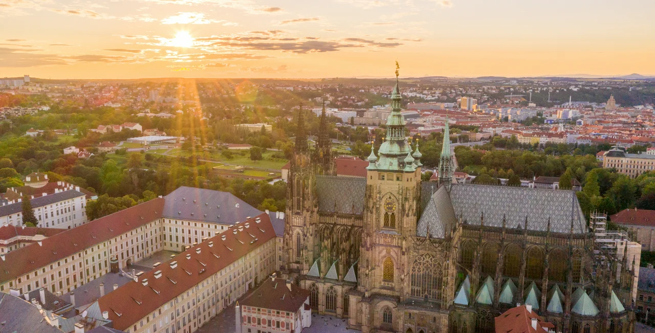 Sun rise over Prague Castle via iStock / Mindaugas Dulinskas