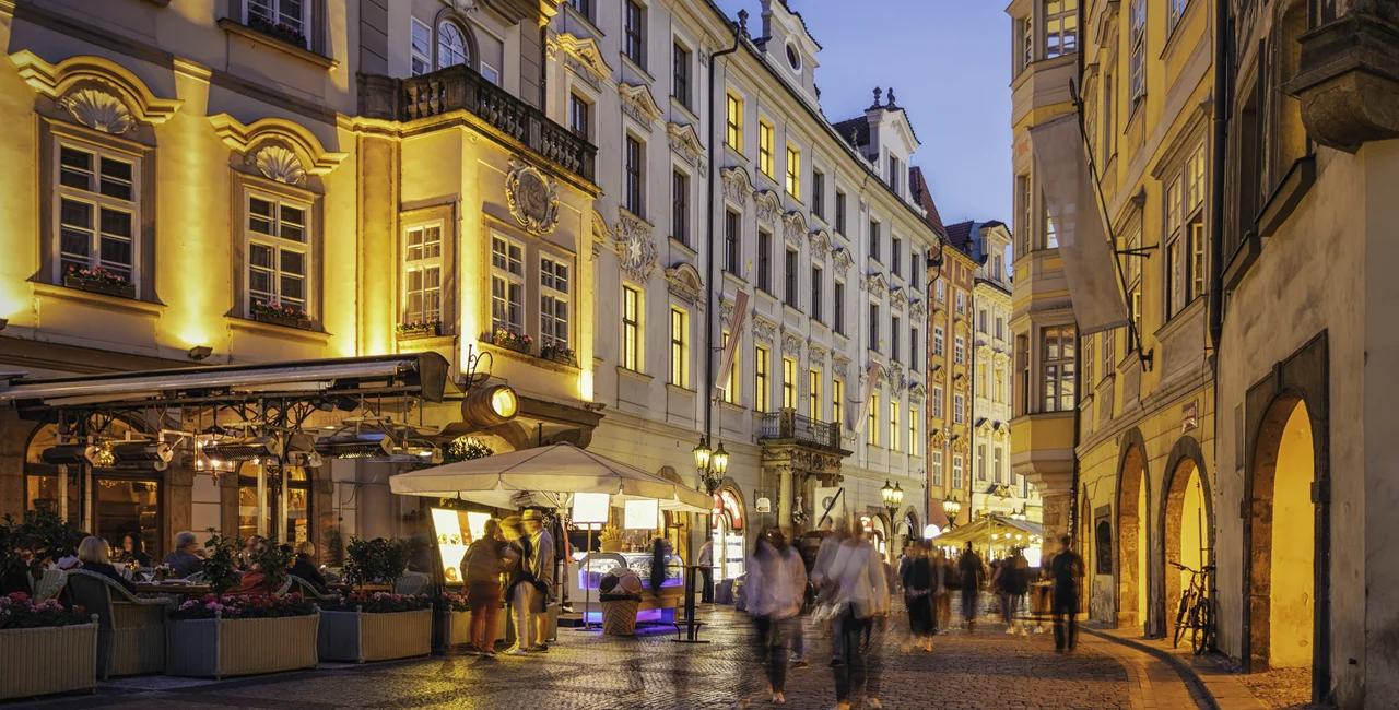 Tourists walking down a street in Prague in the evening. (Photo: iStock, Marcus Lindstrom)