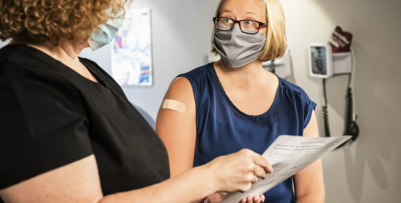 A woman discusses her vaccination. (Photo: Unsplash, CDC)