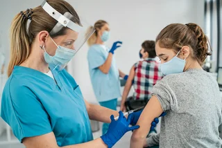 A teenager gets vaccinated against Covid. (Photo: iStock, valentinrussanov)