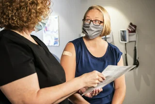 A woman discusses her vaccination. (Photo: Unsplash, CDC)