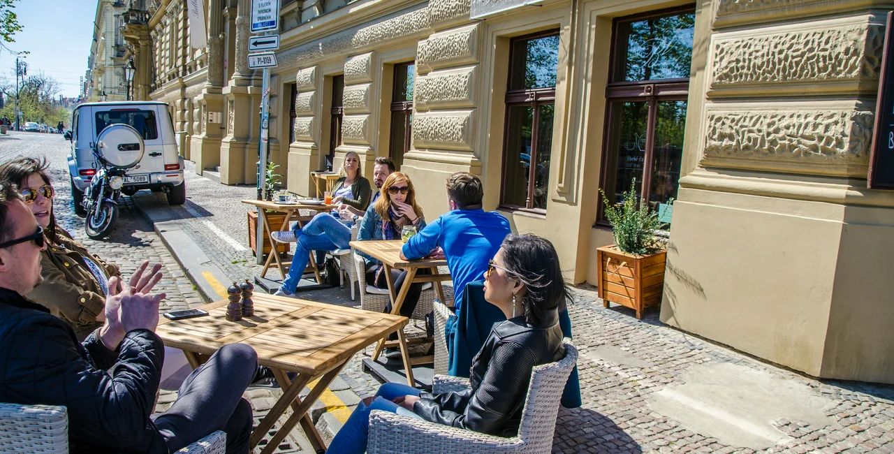 People eating on patio at a restaurant in Prague. (Photo: iStock, Marc Dufresne)