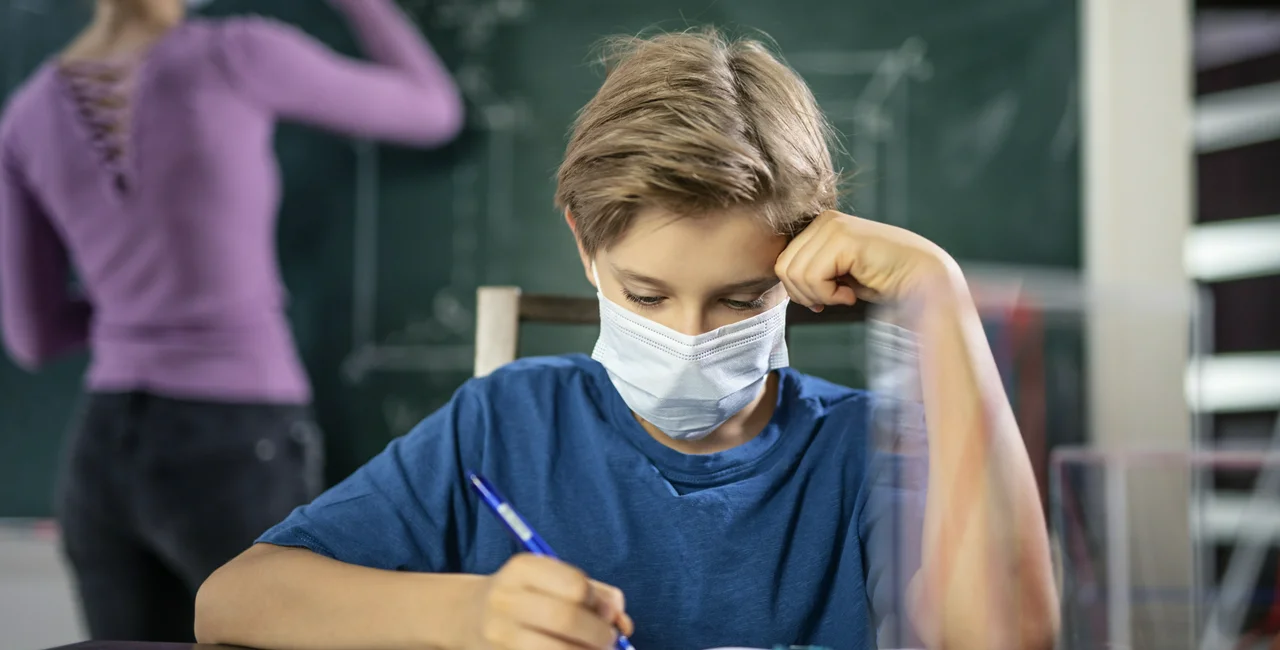 Boy in school classroom wearing face mask. (Photo: iStock, Imgorthand)