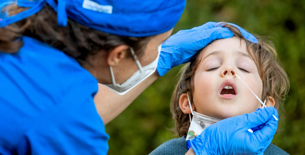 Nurse performing a Covid-19 test on a boy before going back to school. (Photo: iStock, Juanmonino)