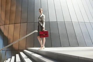 women holding red briefcase