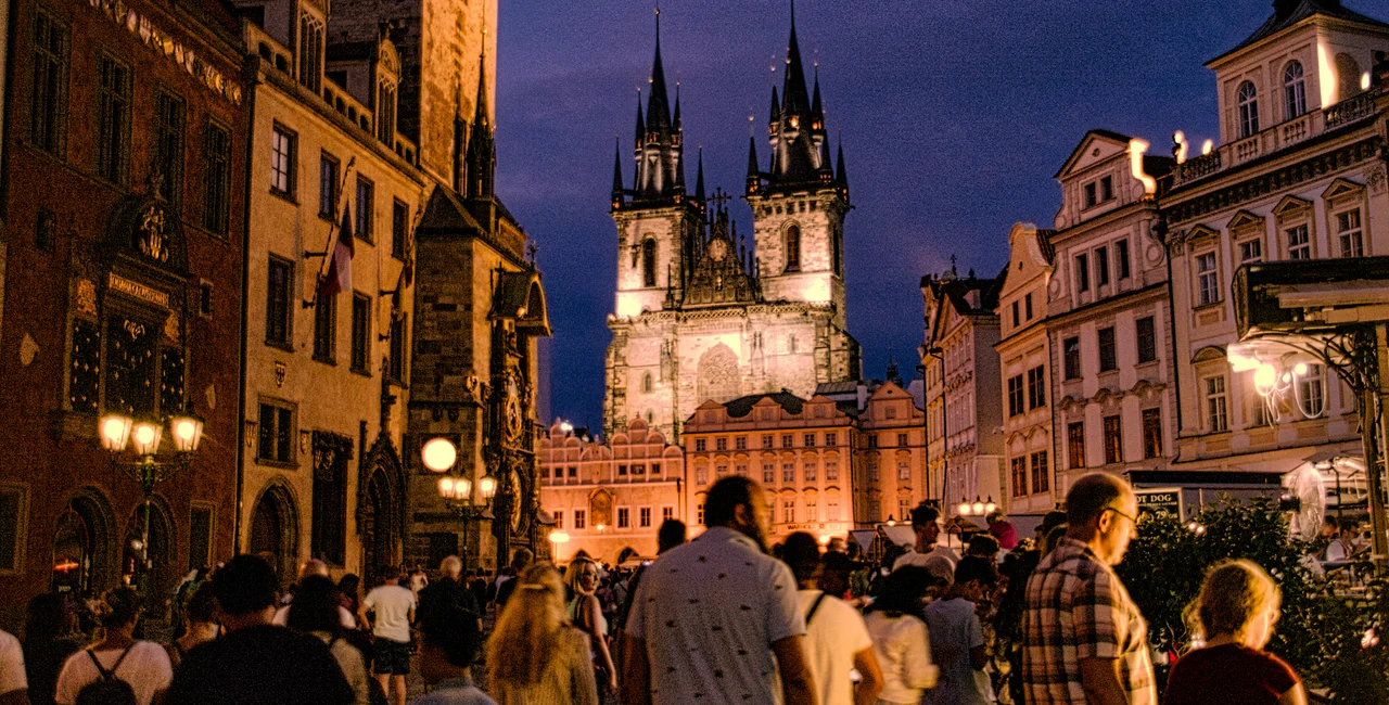 Tourists in Prague's Old Town Square at night. Photo: iStock / JonnyJim