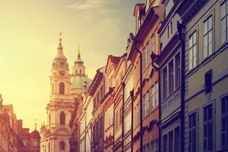 Street in Prague with the St. Nicholas Church in the background / iStock: mammuth