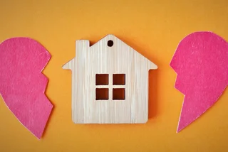 iStock-1270923334 broken heart  Quils Divorce, division of property, poverty and no money concept. Wooden house with broken heart on bright orange background. Mortgage, rent, realtor stock photo CROP 2 for lead