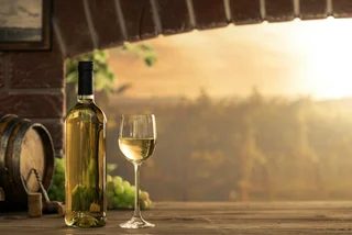 White wine overlooking a vineyard. Photo: iStock / cyano66