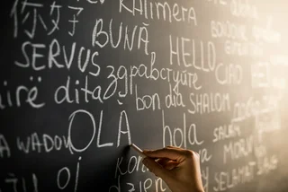 Illustrative image: blackboard hand foreign languages