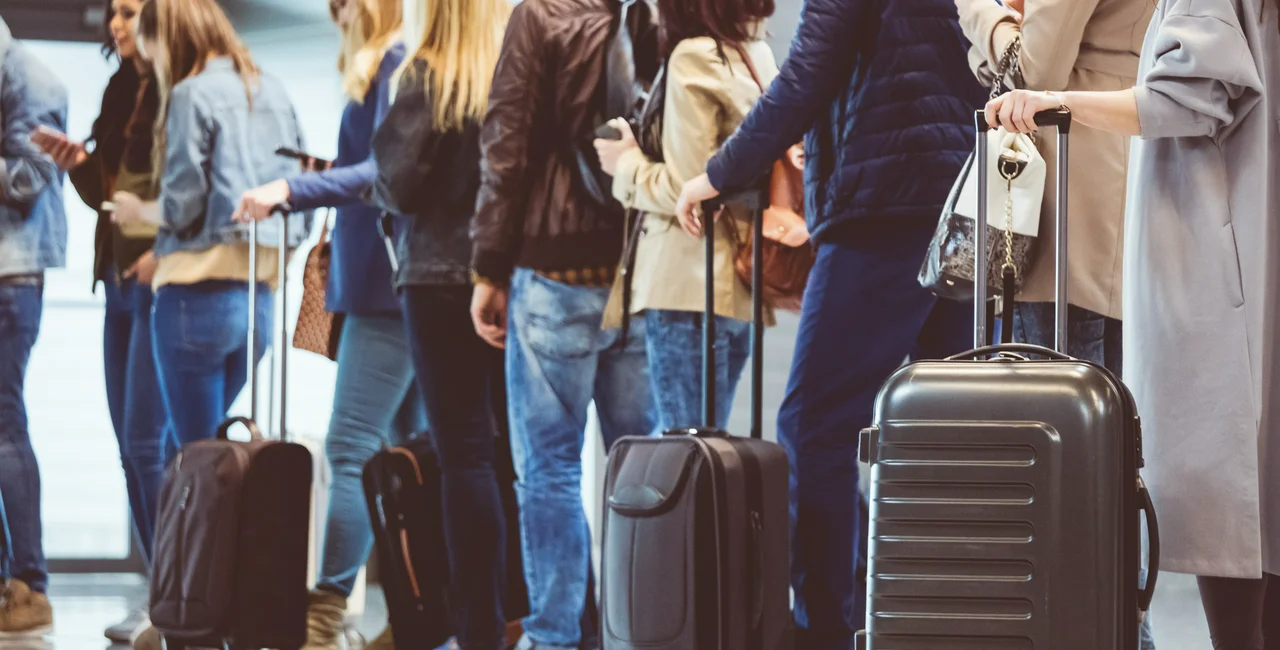 Air travelers with luggage. Photo: iStock, izusek.