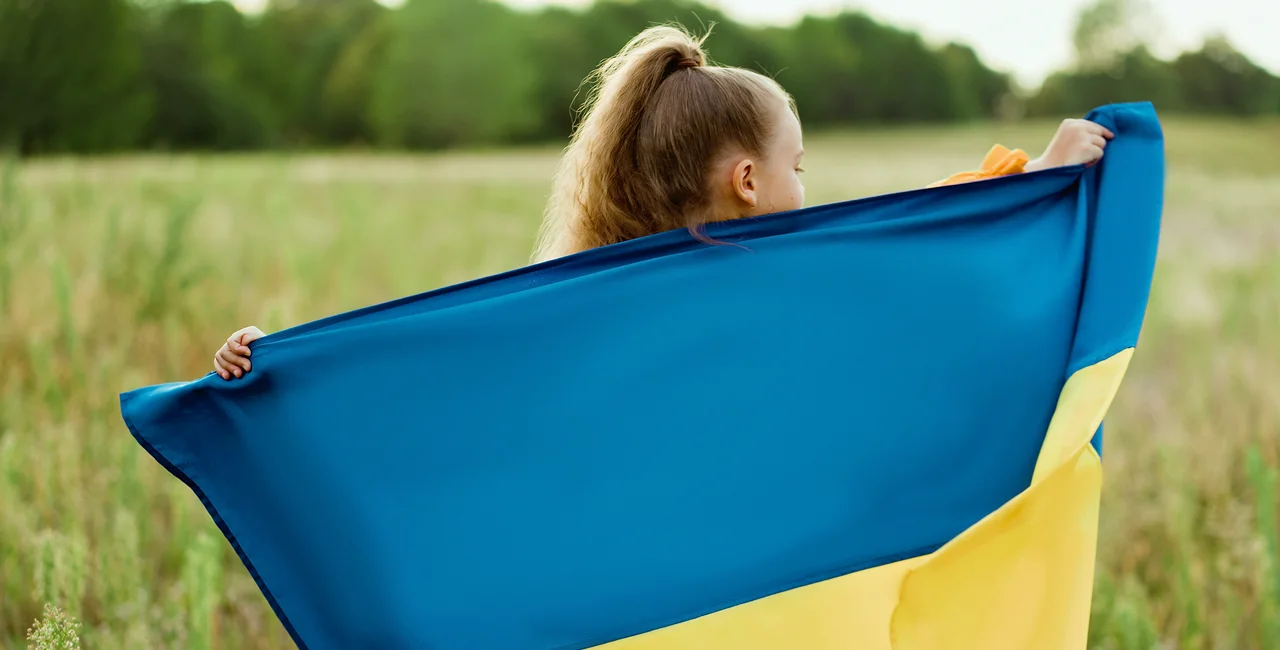 A girl holding Ukrainian flag. Photo: iStock / Copyright