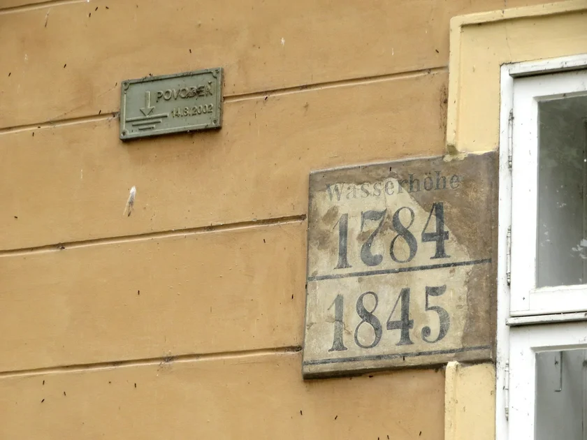 Flood markers on Kampa island show the water level in 2002, 1784, and 1845. Photo: Raymond Johnston.