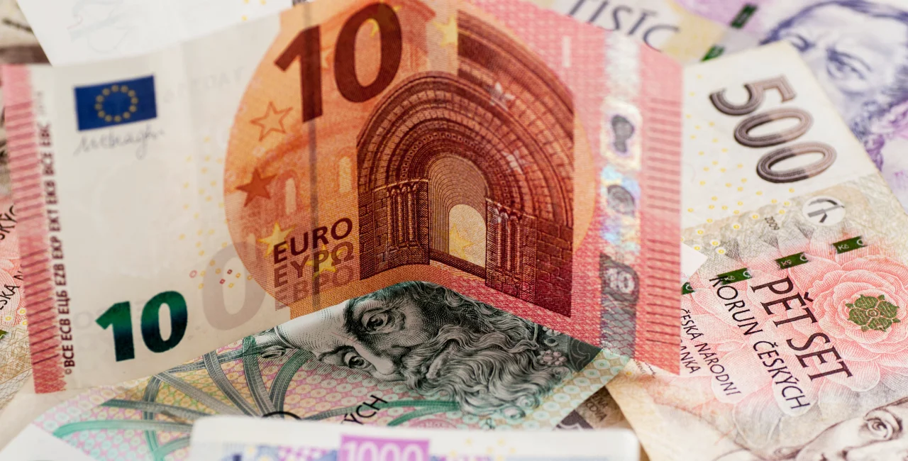 Euro note on top of Czech crowns. Photo: iStock / pfongabe33