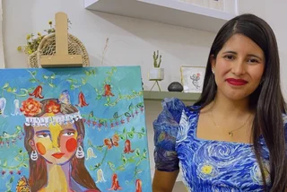 Paz next to one of her paintings