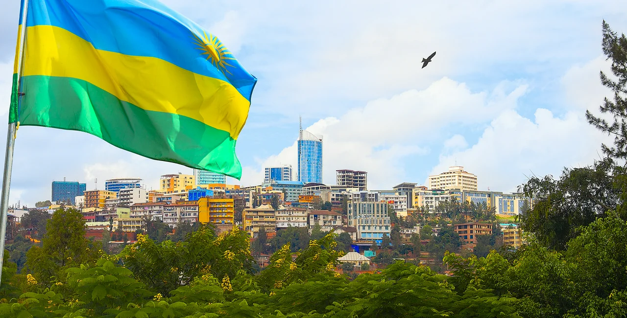 Illustrative view of Kigali business district with offices, towers and residential homes, and Rwanda's flag. iStock - stellalevi