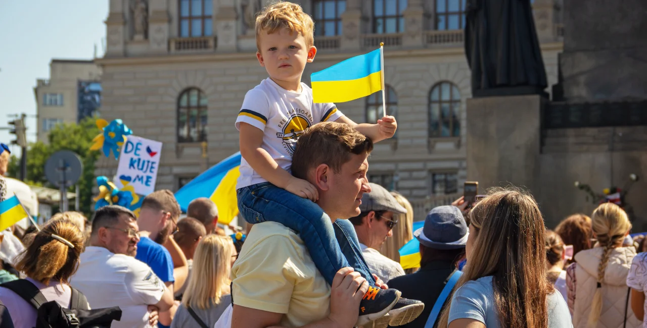 Young boy with a Ukrainian flag in Prague. Photo: Shutterstock /