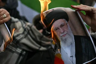 January 17, 2026: People burn a photo depicting Ali Khamenei, Supreme Leader of Iran. Photo: Shutterstock / pcruciatti