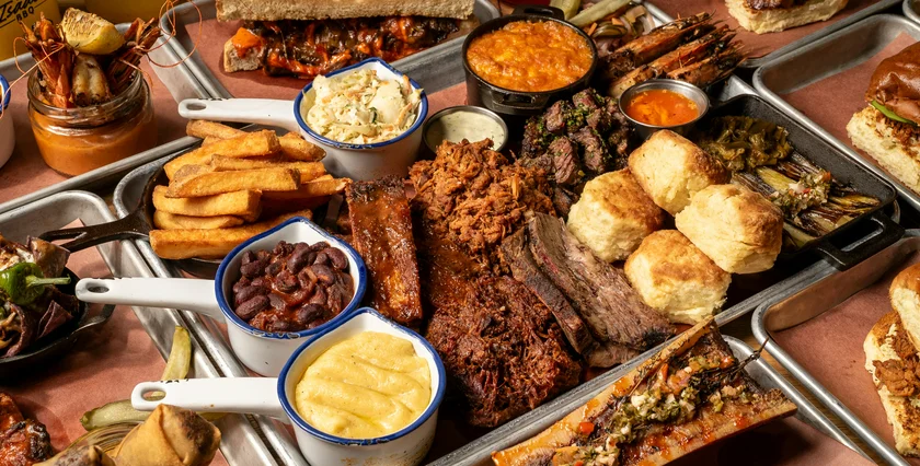 A table full of Isaac’s BBQ favorites, from brisket, pulled pork and ribs to house-made sides, biscuits, pickles and sauces.