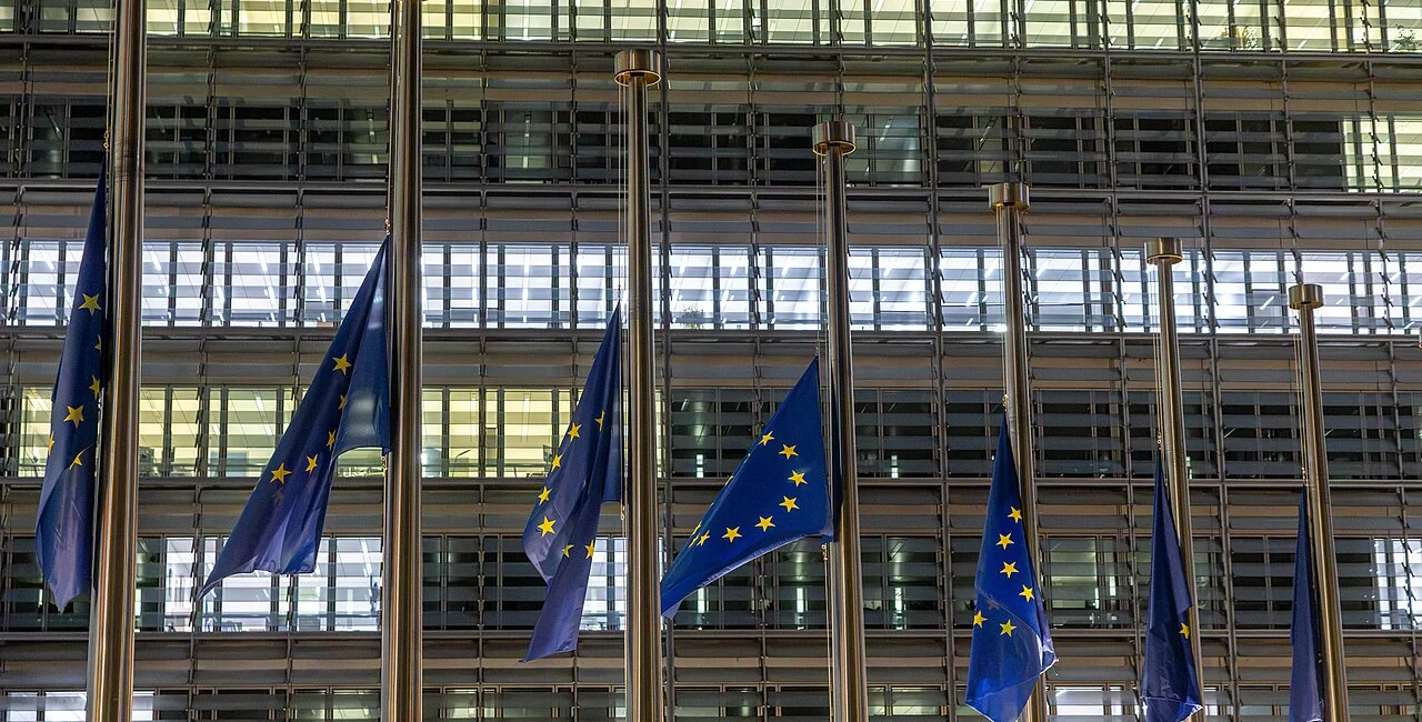 EU flags in Brussels at half-mast following the Oct. 26 crash. Photo: Wikimedia / Aurore Martignoni