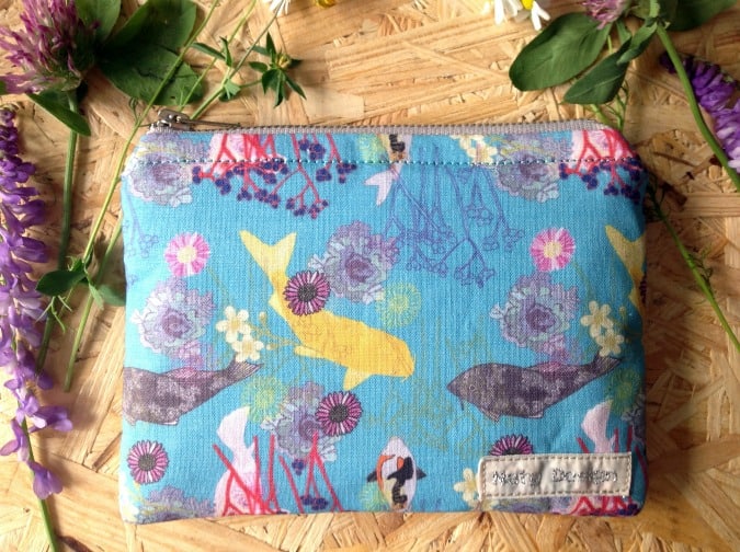 Purse with fish design on wood background