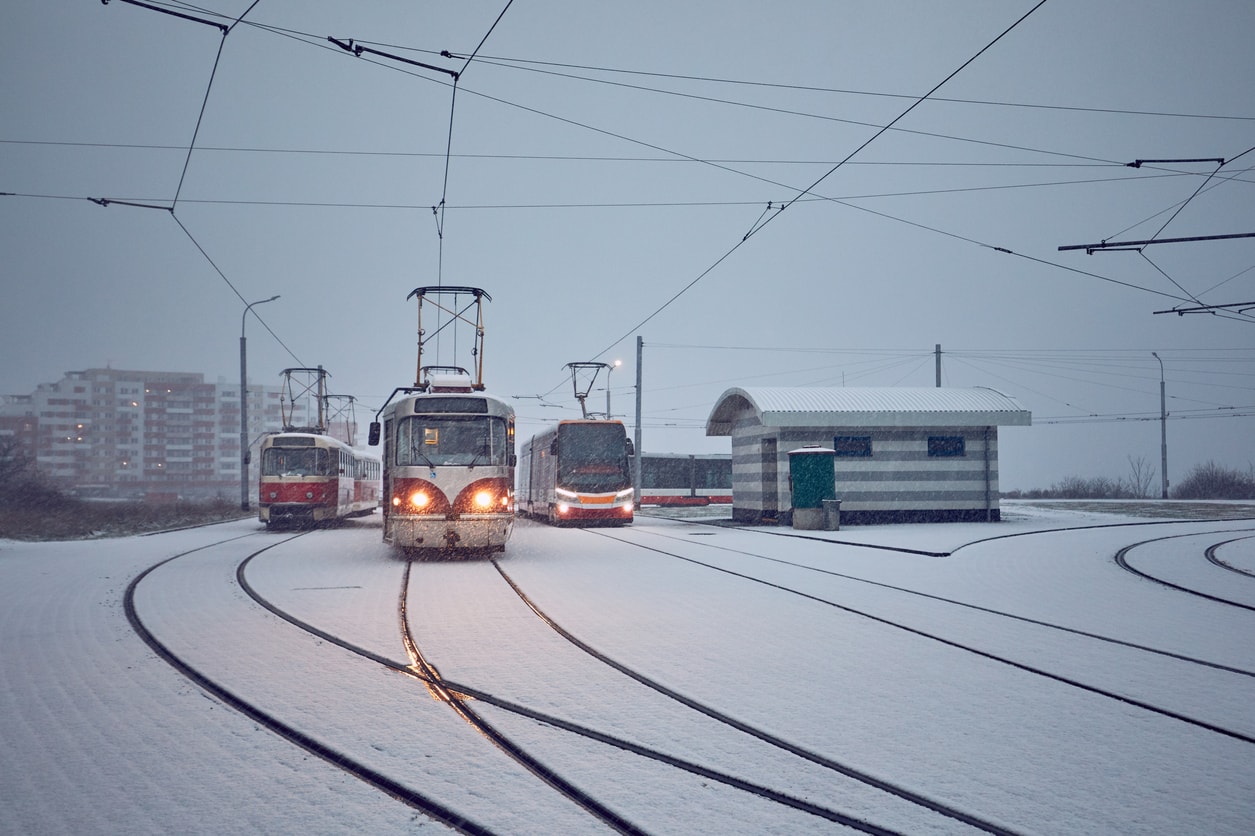 Trams make tracks through heavy snowfall outside Prague's city center.