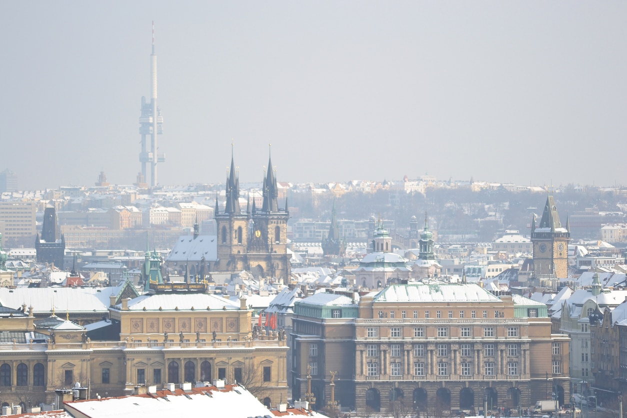 Prague's Old Town district with a light dusting of snow, the TV Tower in the distant background.