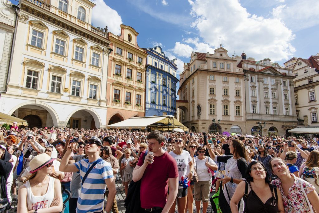Thousands of tourists flood Prague's Old Town Square during the summer season