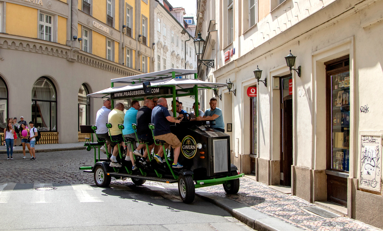 Prague, June 2019 - people pedal through the city on a Beer Bike (via iStock.com / Photoservice)